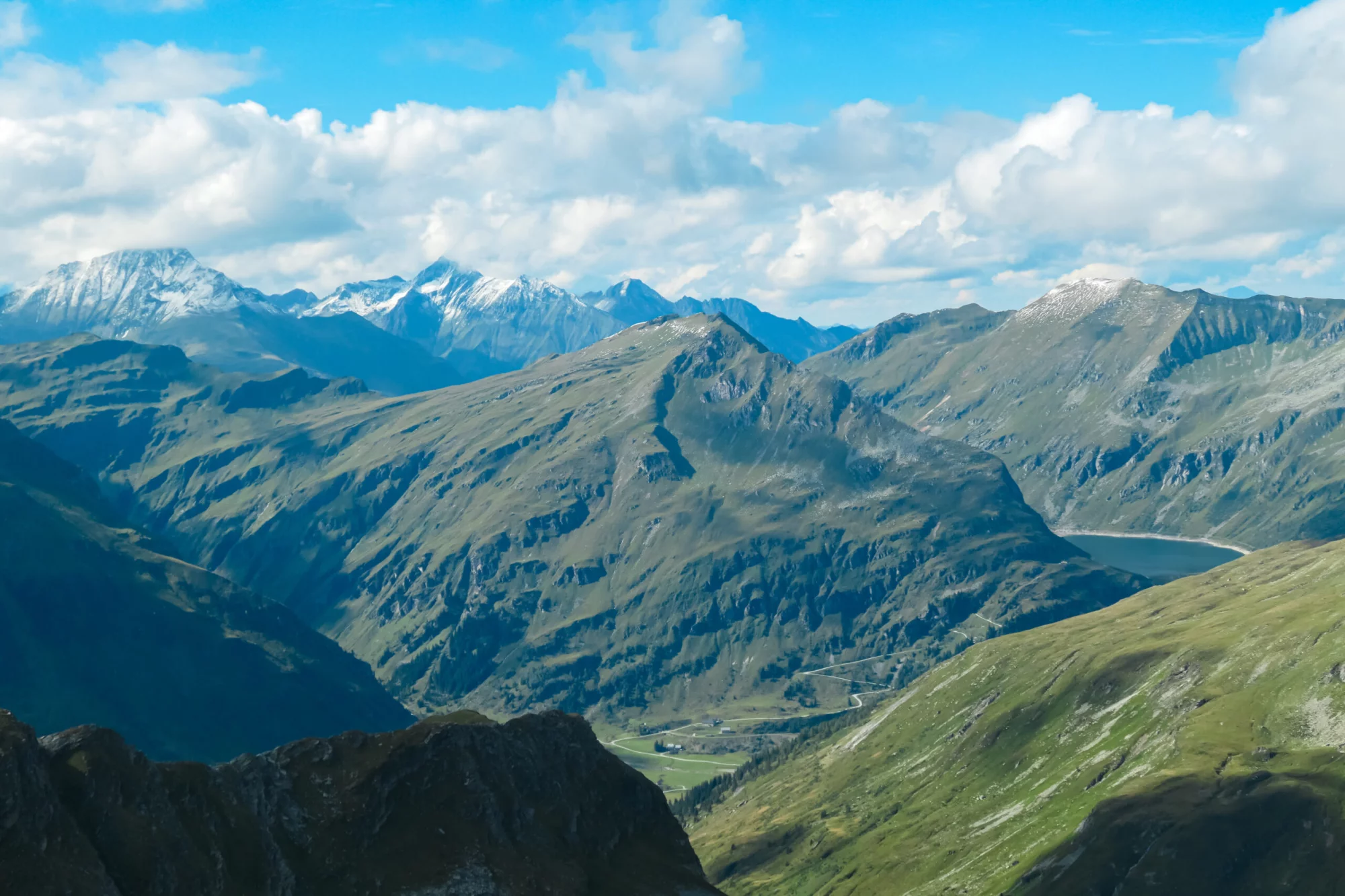 Panoramic view of majestic snow capped mountain peaks in Glockner group in High Tauern National Park, Carinthia Salzburg, Austria. Wanderlust in Austrian Alps. Looking from mount Greilkopf. Escapism
